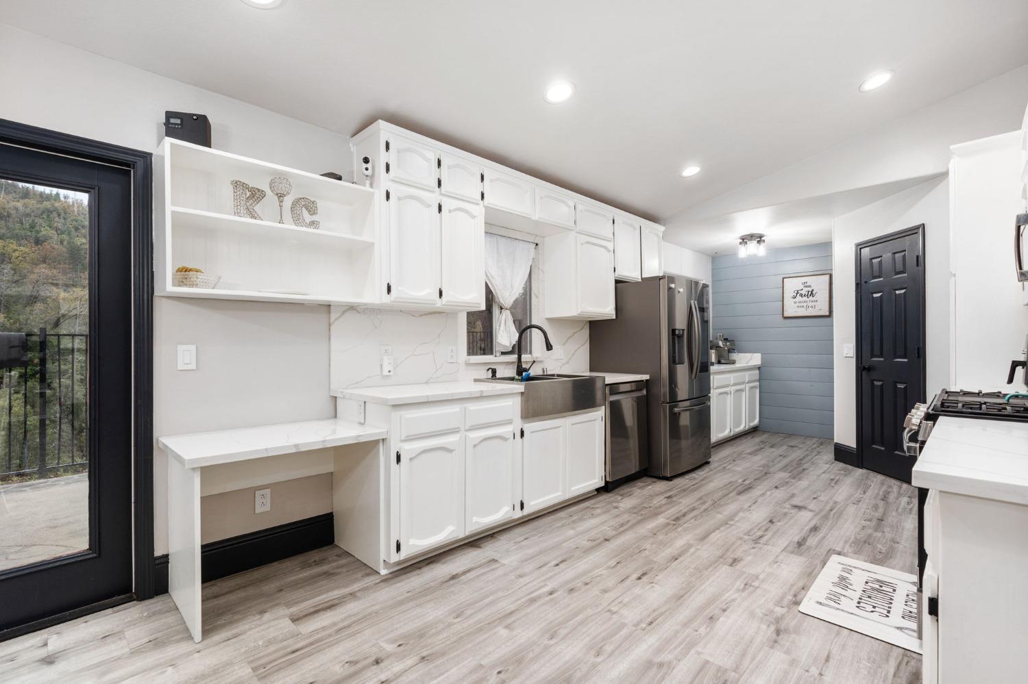36345 Mudge Ranch Road Coarsegold, CA 93614 - Photo 9 of 51 a kitchen with refrigerator a sink and wooden cabinets