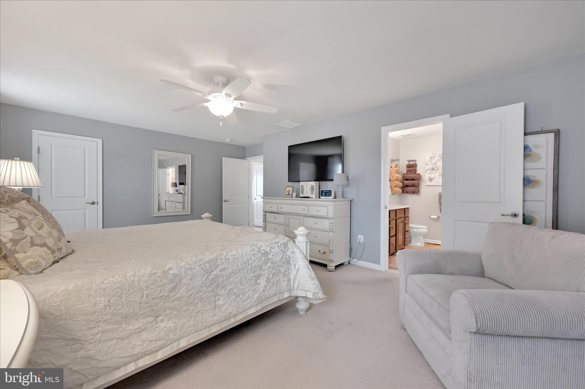 1021 Countryside Road Seven Valleys, PA 17360 - Photo 15 of 36 a spacious bedroom with a bed couch and a flat screen tv