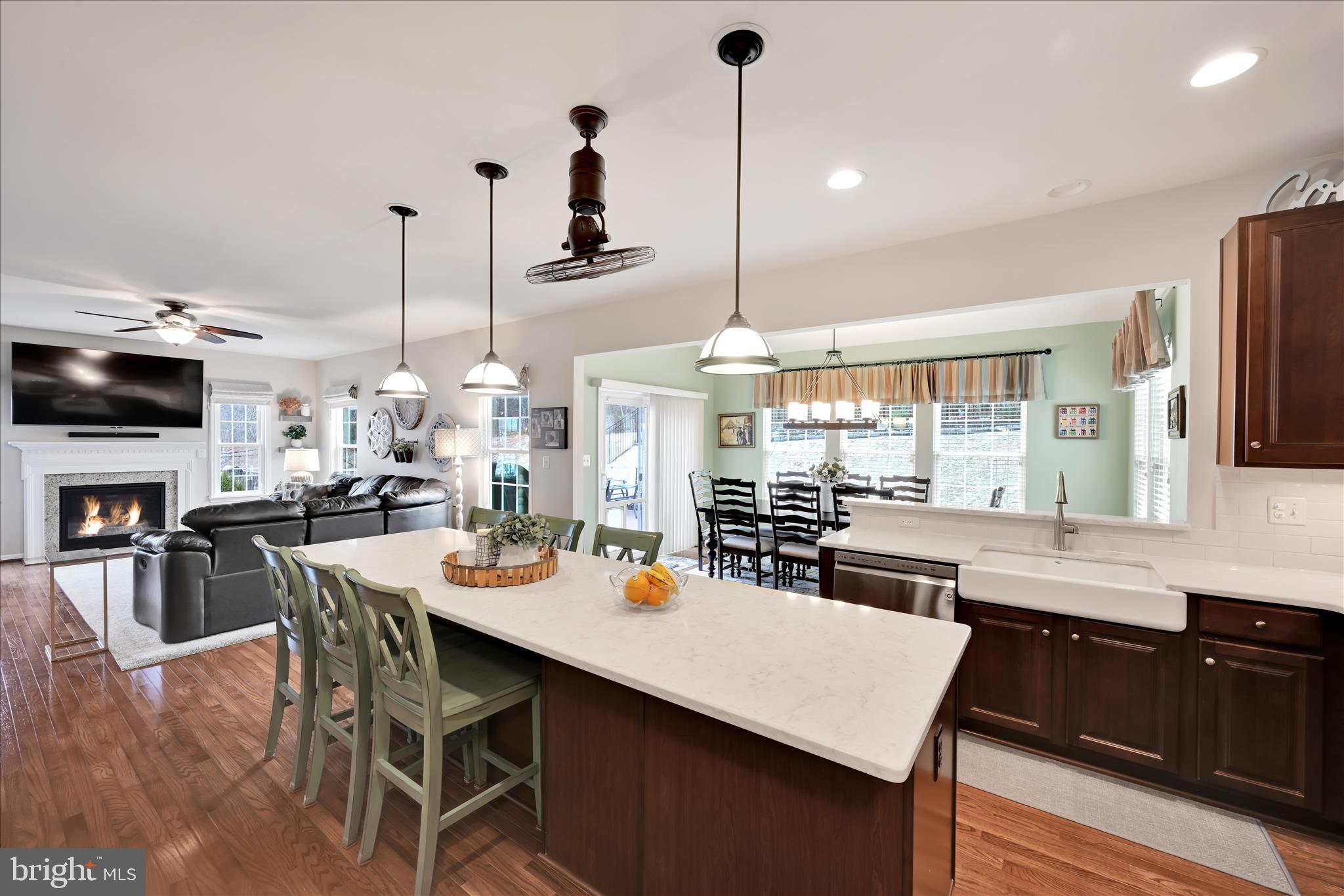 1021 Countryside Road Seven Valleys, PA 17360 - Photo 8 of 36 a kitchen with stainless steel appliances kitchen island granite countertop a table chairs in it and wooden floors