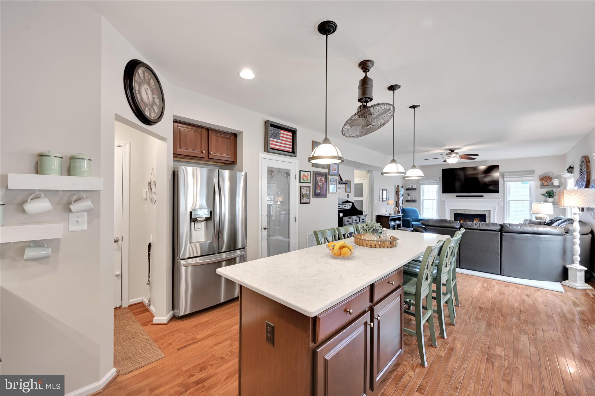 1021 Countryside Road Seven Valleys, PA 17360 - Photo 9 of 36 a kitchen with stainless steel appliances granite countertop a stove a refrigerator a oven a sink with island chairs and wooden floor