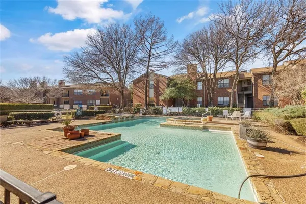 a view of a swimming pool with lounge chairs