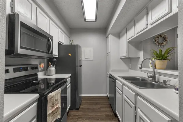 a kitchen with stainless steel appliances granite countertop a stove and a microwave