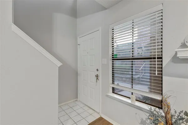 a view of a dining room with furniture a kitchen and chandelier fan