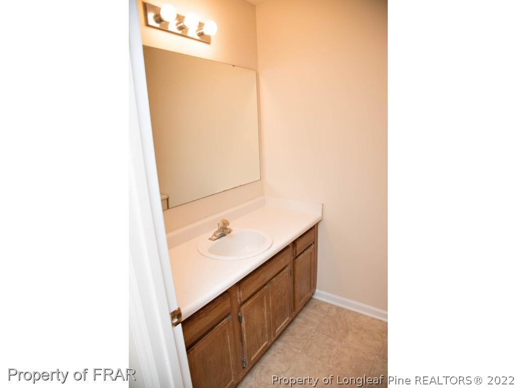 705 Rim Road Fayetteville, NC 28314 - Photo 13 of 26 a bathroom with a sink and a mirror