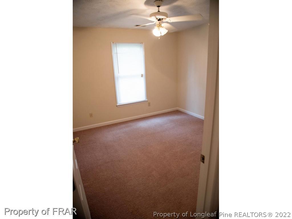 705 Rim Road Fayetteville, NC 28314 - Photo 16 of 26 a view of a room with a ceiling fan and a window