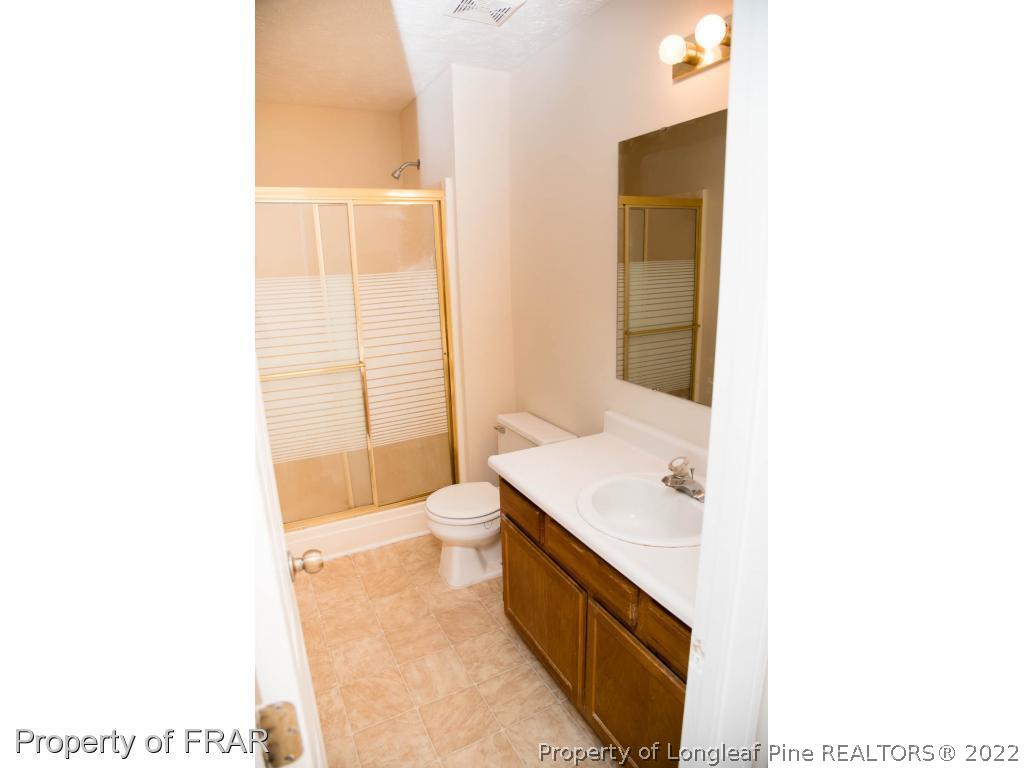 705 Rim Road Fayetteville, NC 28314 - Photo 20 of 26 a bathroom with a sink a toilet and shower