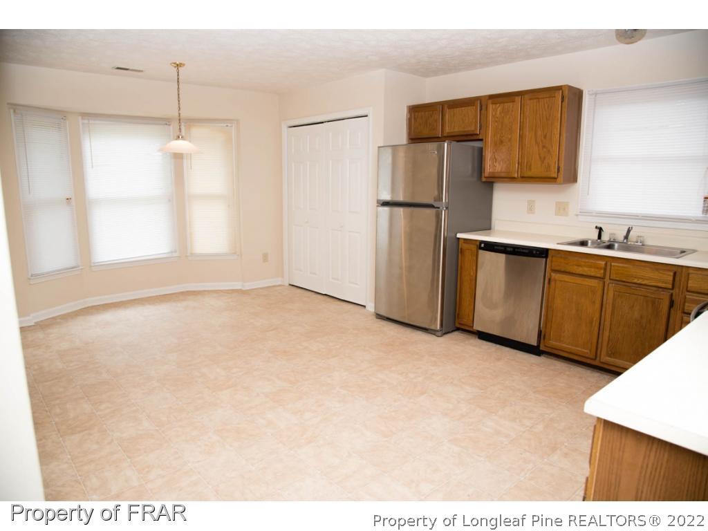 705 Rim Road Fayetteville, NC 28314 - Photo 3 of 26 a kitchen with stainless steel appliances granite countertop a refrigerator and a sink