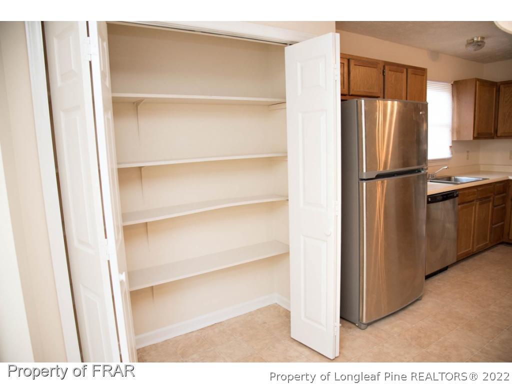 705 Rim Road Fayetteville, NC 28314 - Photo 4 of 26 a kitchen with cabinets and stainless steel appliances