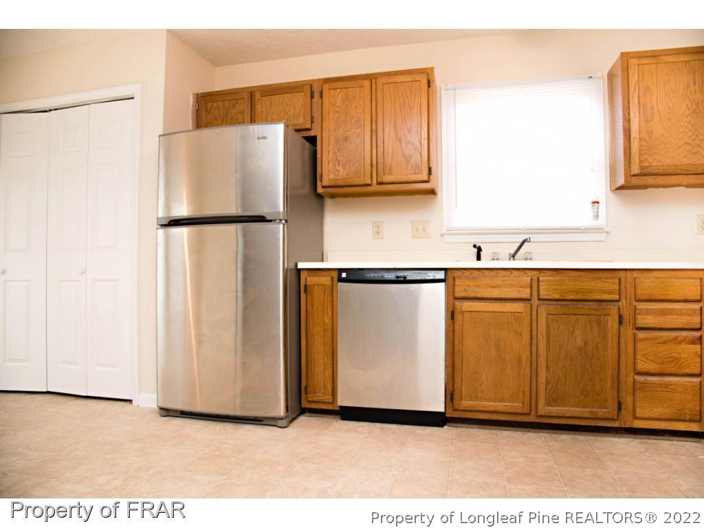 705 Rim Road Fayetteville, NC 28314 - Photo 6 of 26 a kitchen with cabinets and stainless steel appliances