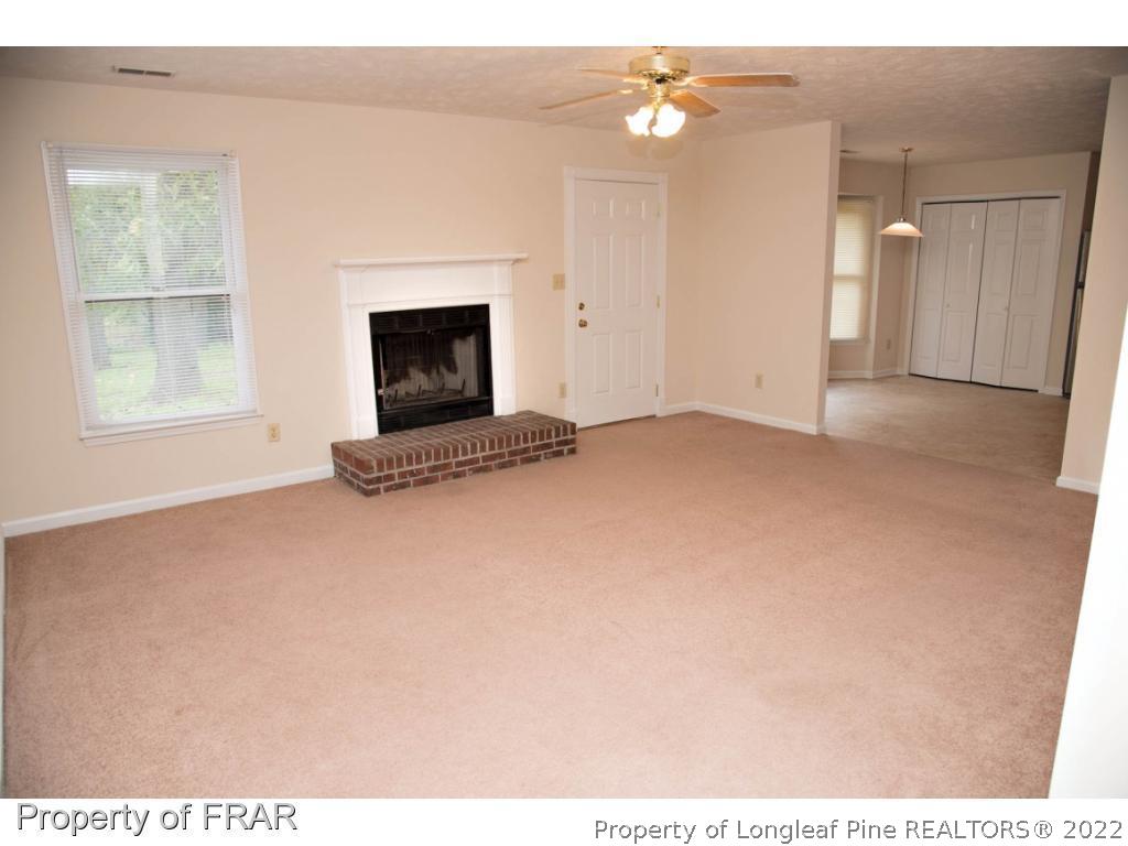 705 Rim Road Fayetteville, NC 28314 - Photo 8 of 26 a view of an empty room with a fireplace and a window