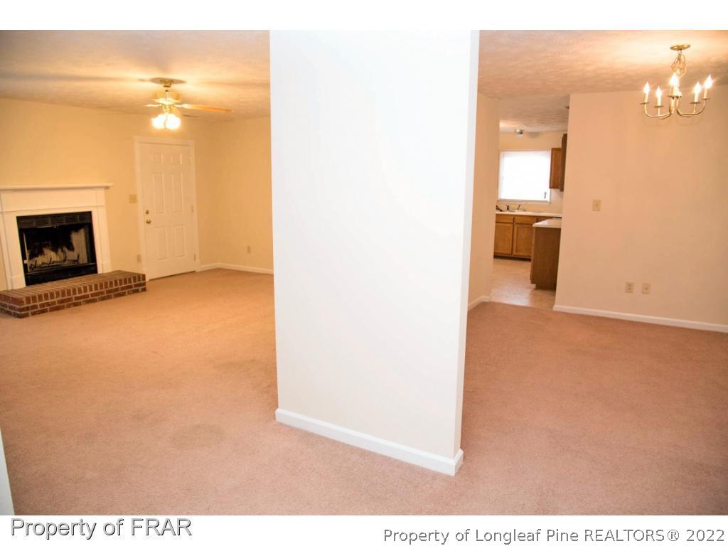 705 Rim Road Fayetteville, NC 28314 - Photo 10 of 26 a view of a livingroom with wooden floor and a fireplace