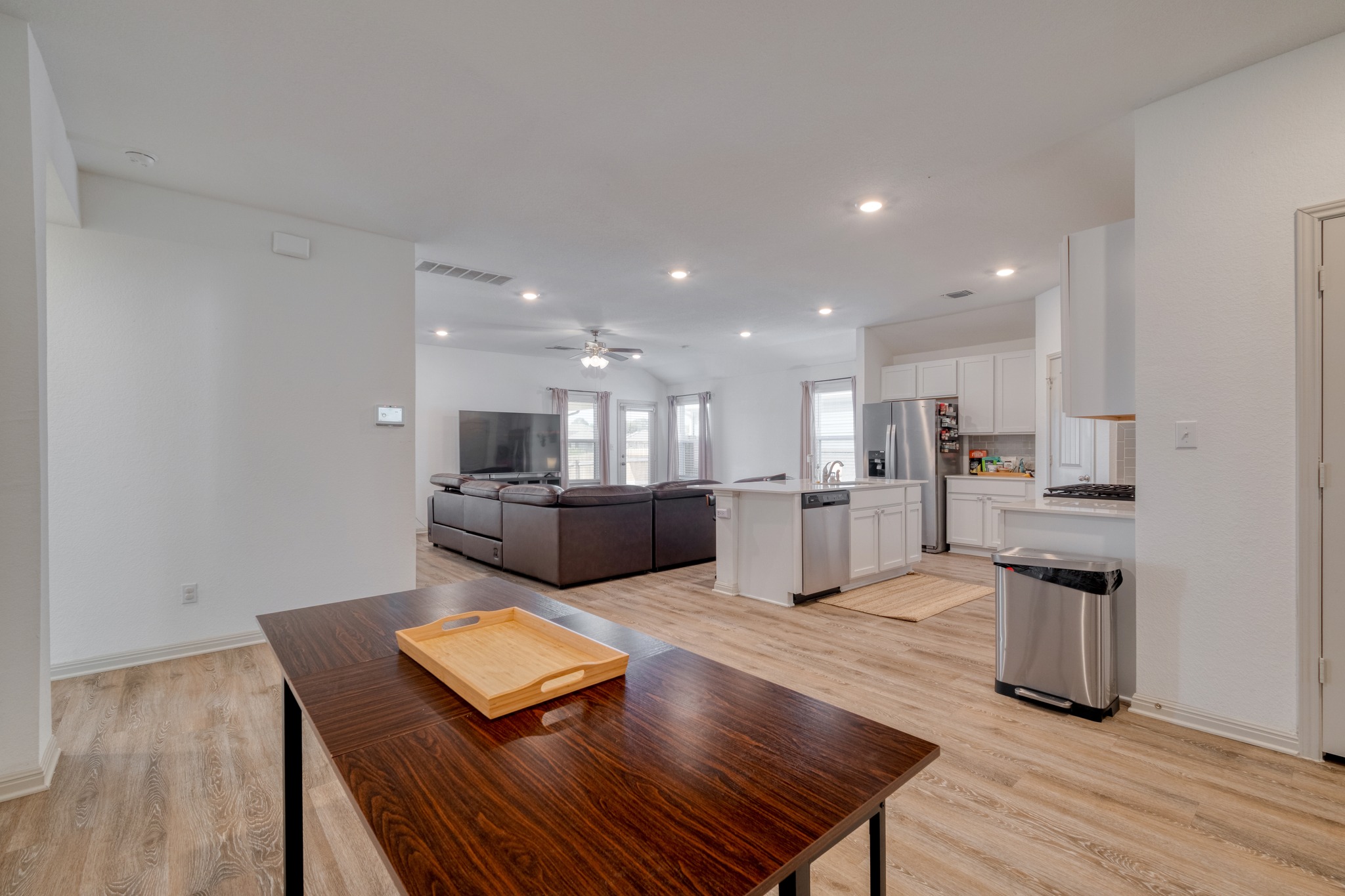 102 Johnson Draw Road Hutto, TX 78634 - Photo 30 of 30 An open floorplan seamlessly connects the living areas over wood-look flooring.