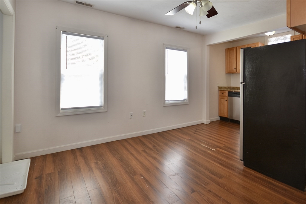151-153 Main Street Bourne, MA 02532 - Photo 13 of 14 a view of an empty room with wooden floor and a window