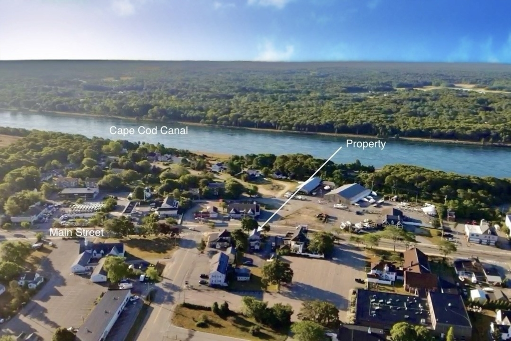151-153 Main Street Bourne, MA 02532 - Photo 14 of 14 an aerial view of a city with lots of residential buildings and lake view