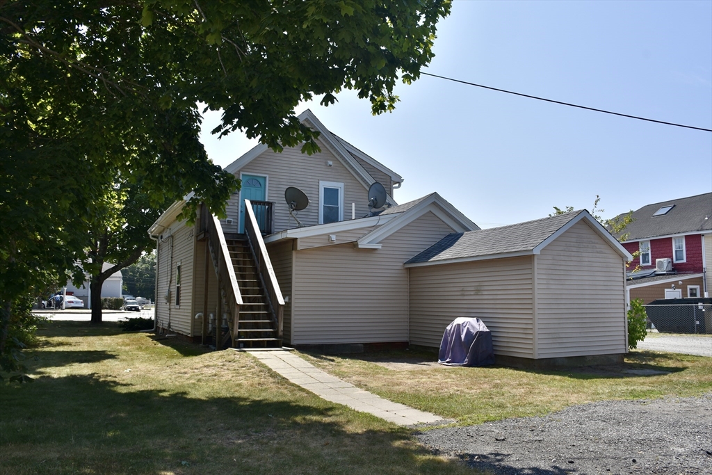 151-153 Main Street Bourne, MA 02532 - Photo 4 of 14 a view of a house with backyard