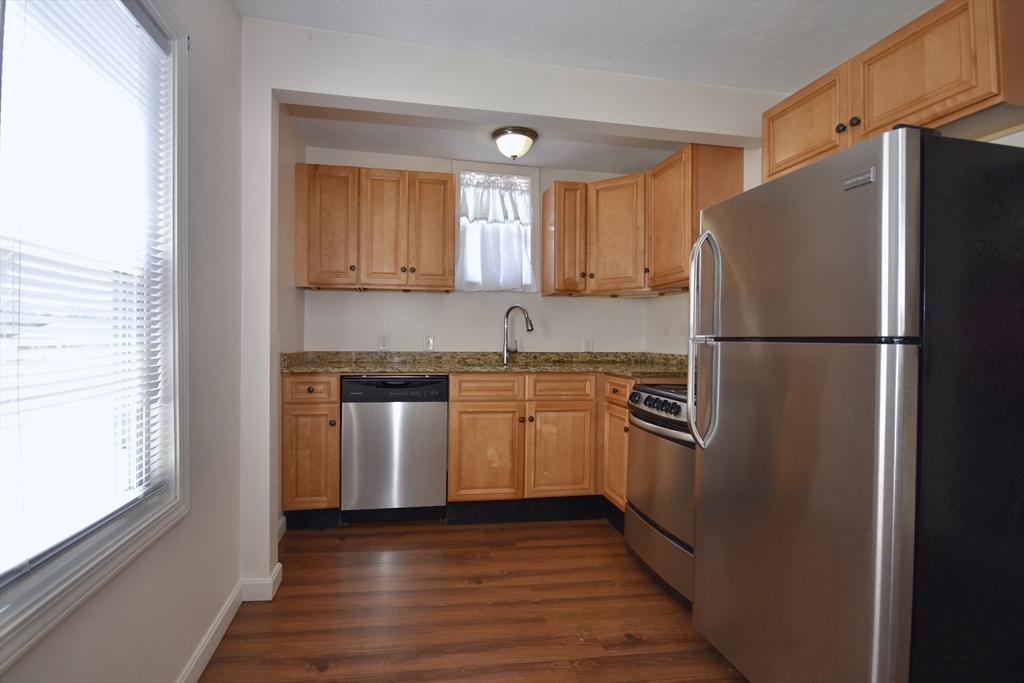 151-153 Main Street Bourne, MA 02532 - Photo 8 of 14 a kitchen with a refrigerator sink and stove