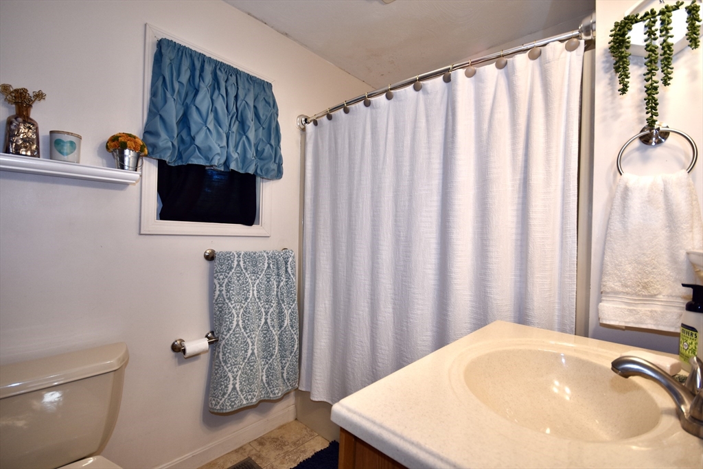 151-153 Main Street Bourne, MA 02532 - Photo 9 of 14 a bathroom with a sink toilet and shower