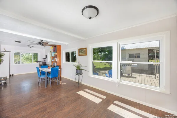 a view of a dining room with furniture window and wooden floor