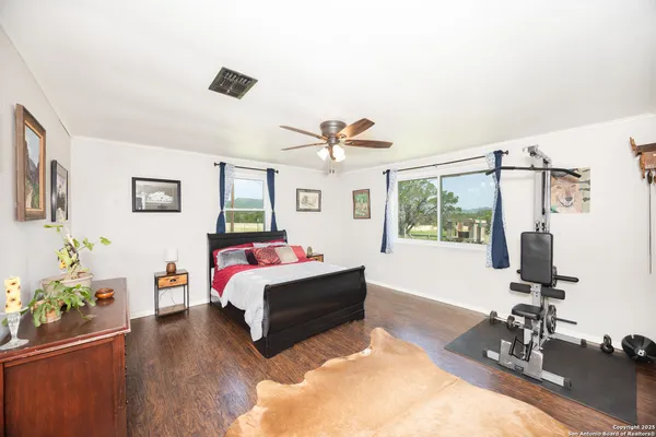 a bedroom with a large bed and a window