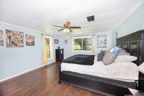 a bedroom with a bed and wooden floor