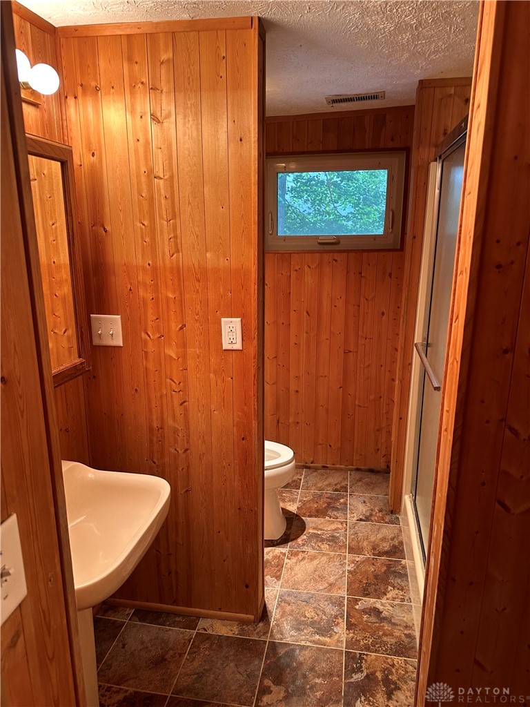 1358 Hanes Road Dayton, OH 45434 - Photo 12 of 21 This cozy bathroom features natural wood paneling and practical tile flooring.