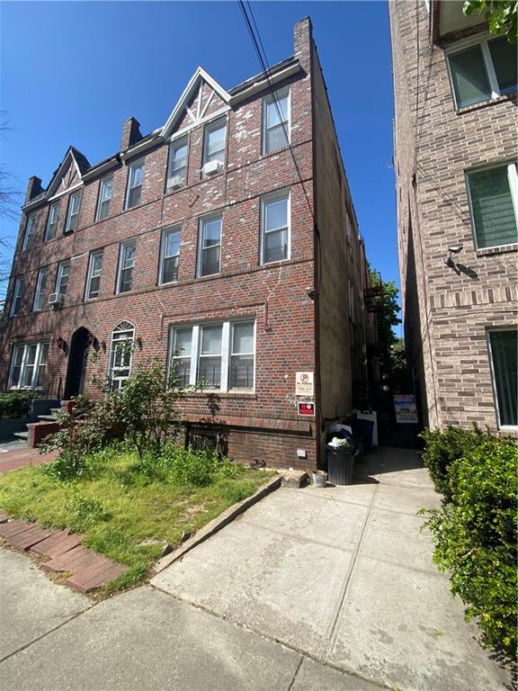 1586 East 22nd Street, Unit 6 Brooklyn, NY 11210 - Photo 4 of 7 a view of a brick building next to a yard