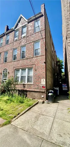 a view of a brick house with a yard