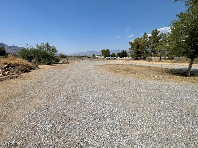 2151 West Simkins Road Pahrump, NV 89060 - Photo 4 of 23 View of dirt / gravel road featuring a mountain view