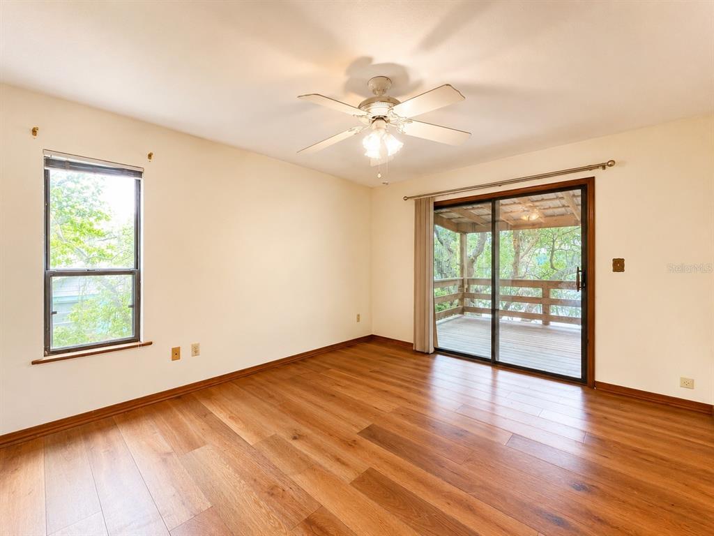 7119 Immokalee Road Keystone Heights, FL 32656 - Photo 18 of 50 a view of an empty room with wooden floor and a window