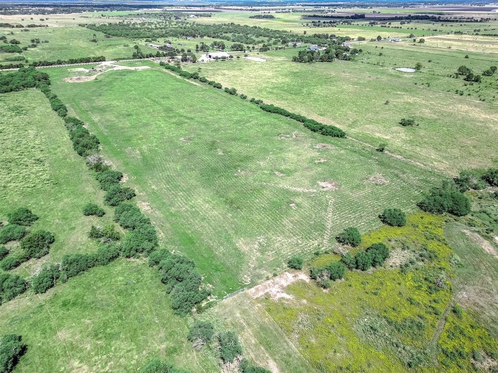 13931 Routt Point Road Needville, TX 77461 - Photo 8 of 11 Aerial view of the homesite showing open pastureland, natural tree lines, and surrounding rural acreage.