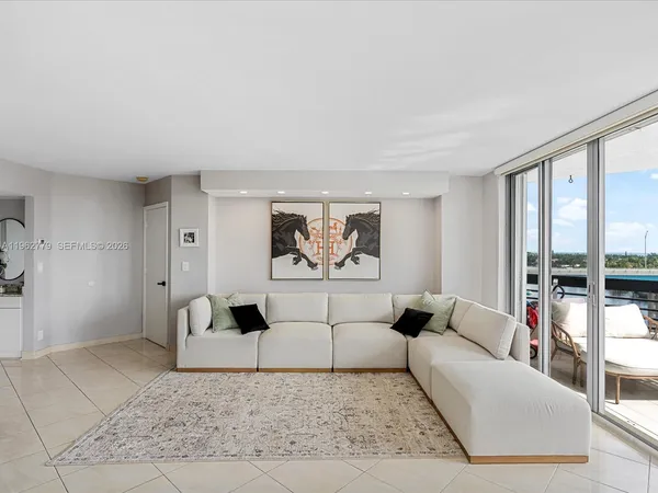 a dining room with furniture water view and a floor to ceiling window