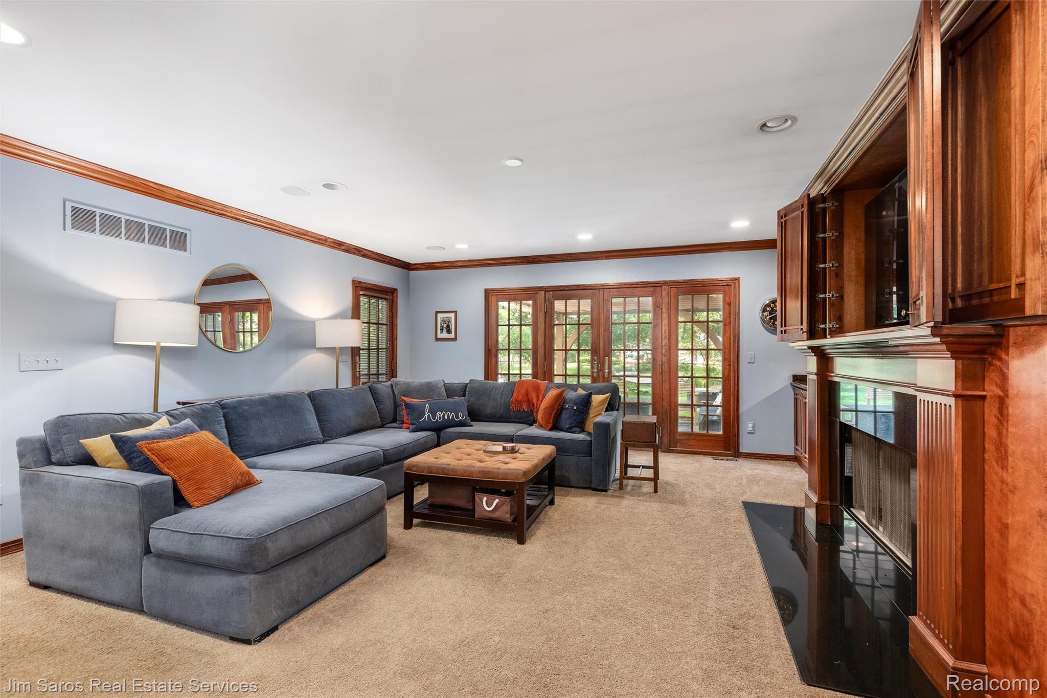820 Westchester Road Grosse Pointe, MI 48230 - Photo 8 of 33 Living area with crown molding, light colored carpet, french doors, recessed lighting, and a fireplace with flush hearth