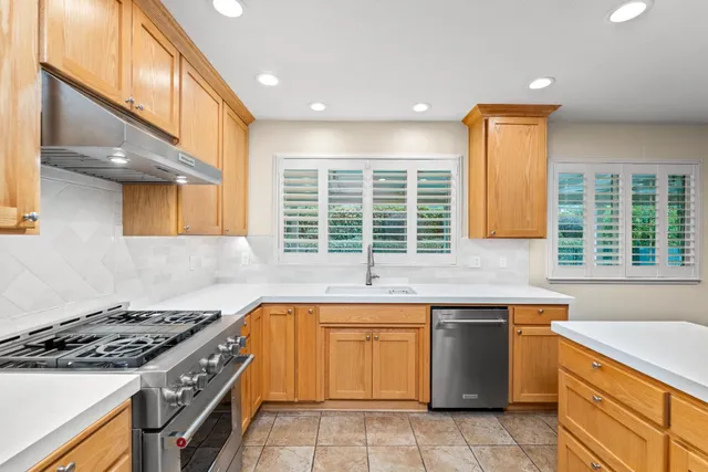 a kitchen with a stove a sink and a refrigerator