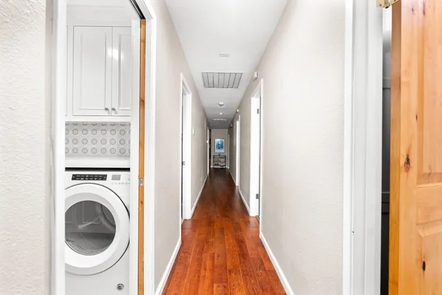 a view of a hallway with washer and dryer