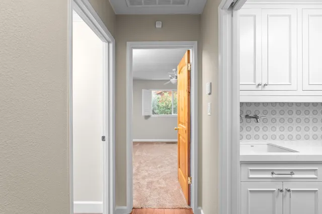 a view of a bathroom with a door and a mirror