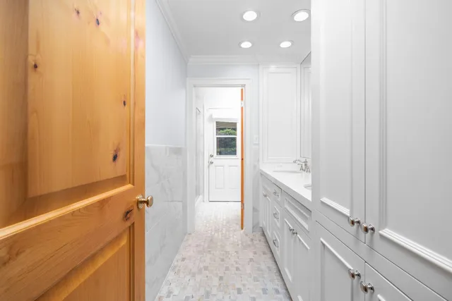 a bathroom with a double vanity sink and a bathtub