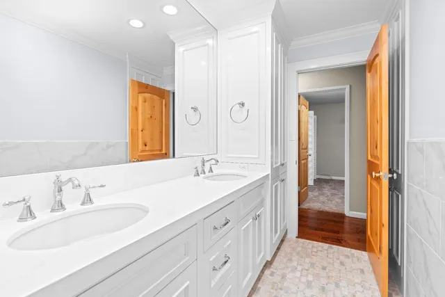 a bathroom with a double vanity sink and a mirror