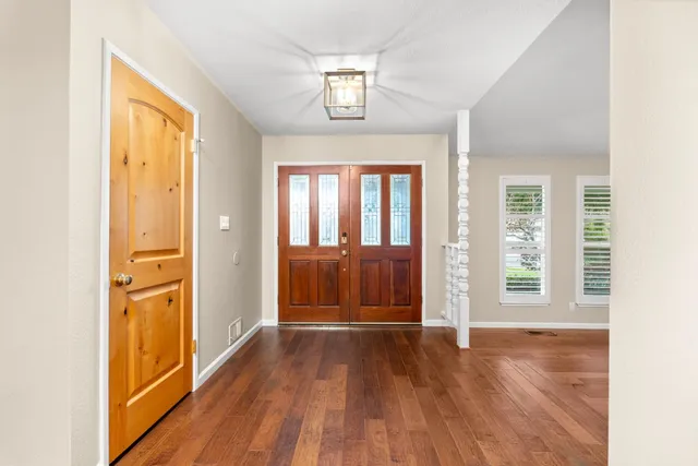 wooden floor in an empty room with a window