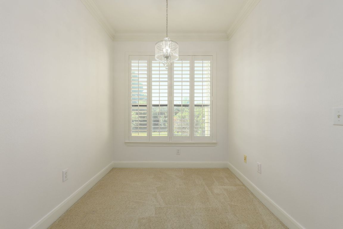 7701 Rialto Boulevard, Unit 1116 Austin, TX 78735 - Photo 19 of 26 an empty room with windows and chandelier