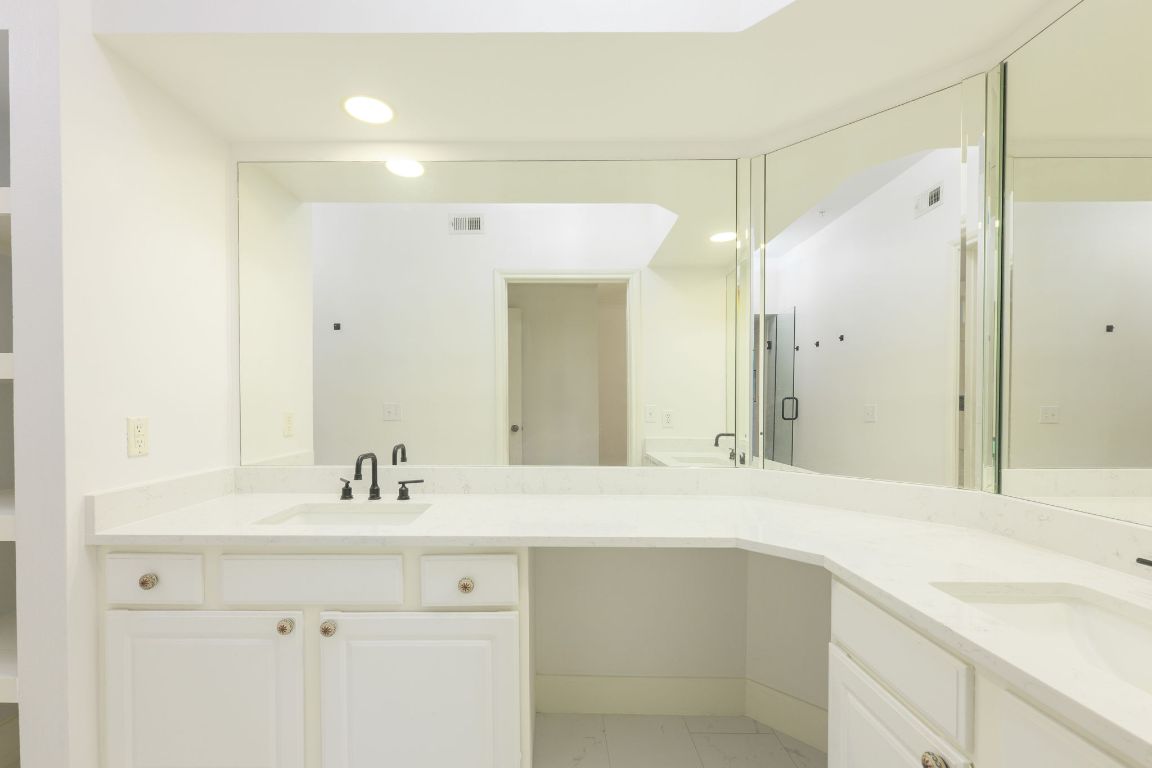 7701 Rialto Boulevard, Unit 1116 Austin, TX 78735 - Photo 21 of 26 a bathroom with a sink and a mirror