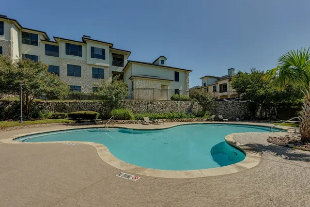 a view of a house with swimming pool and porch