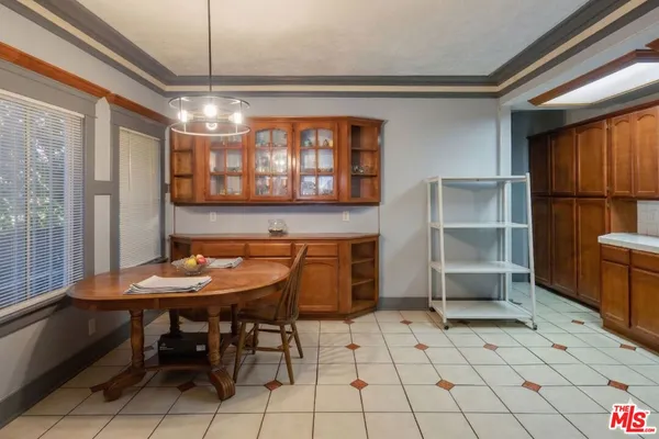 a room with furniture a window and stainless steel appliances