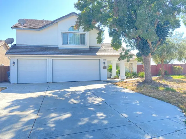 a view of a house with a yard and garage