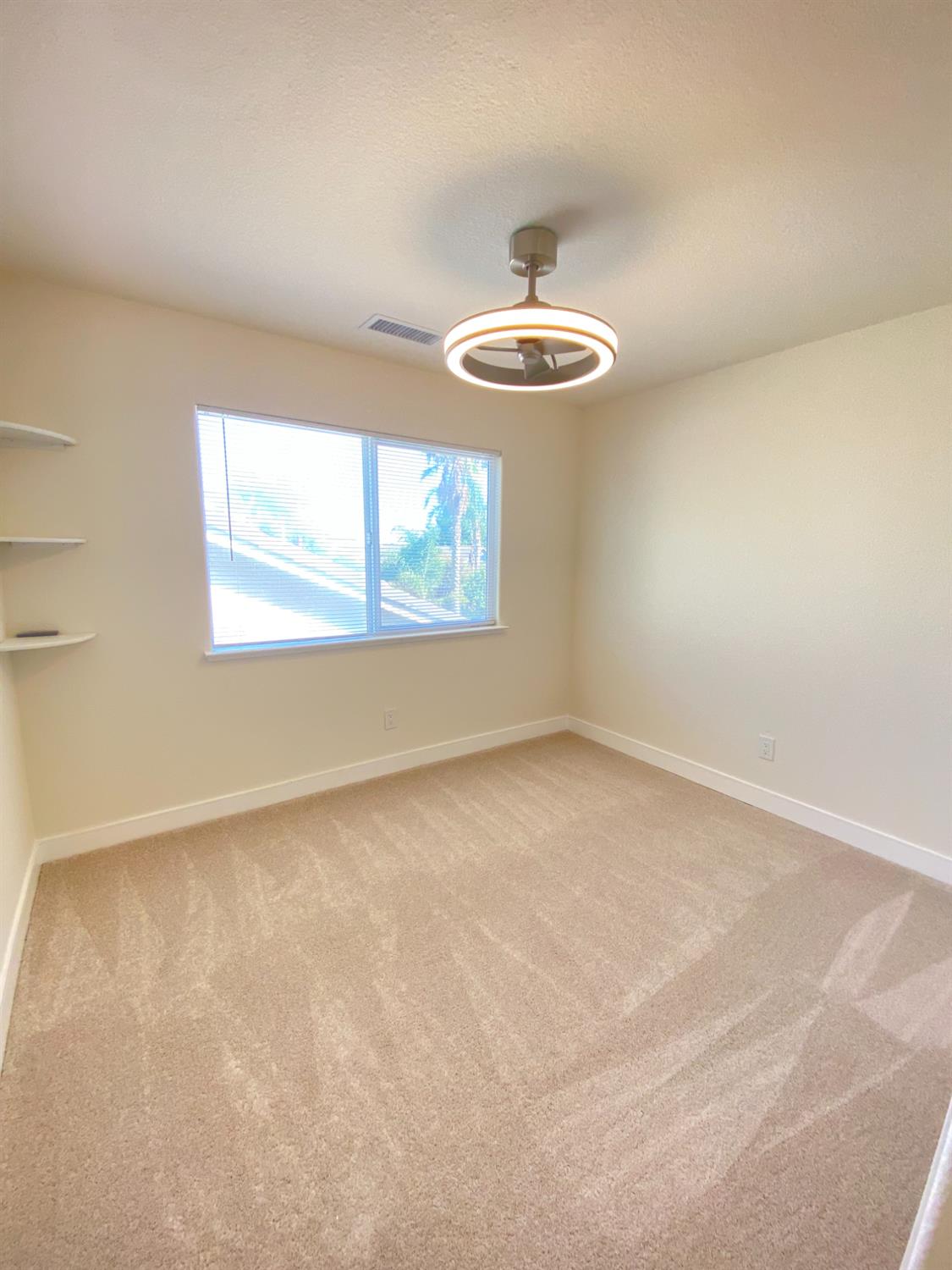 1716 Via Milano Gustine, CA 95322 - Photo 18 of 28 an empty room with windows and fan