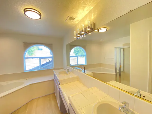 a spacious bathroom with a large tub and a large window