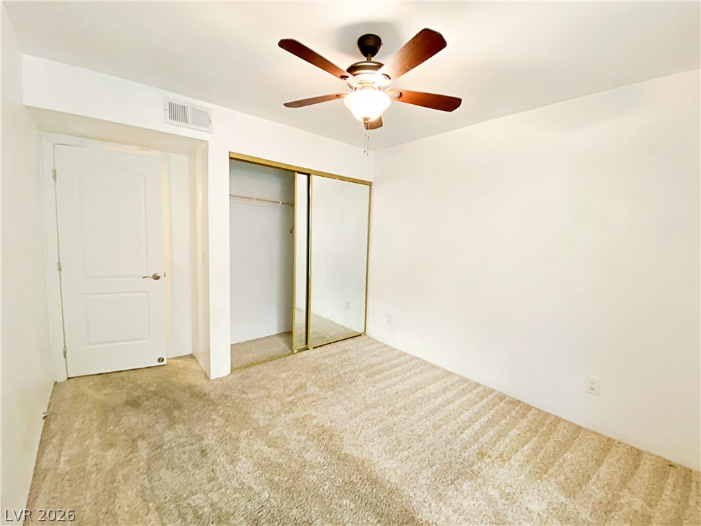 3145 East Flamingo Road, Unit 1128 Las Vegas, NV 89121 - Photo 12 of 19 A well-proportioned bedroom with ceiling fan and mirrored closet doors provides ample personal space.