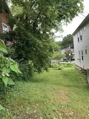 a view of a green field with lots of bushes