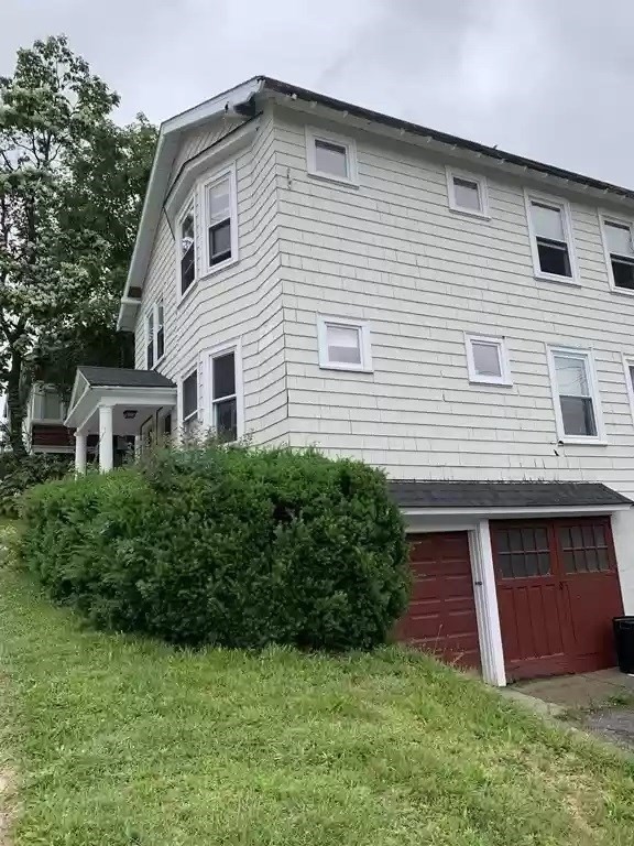28 Tip Top Street, Unit 1 Boston, MA 02135 - Photo 13 of 13 a front view of a house with a garden