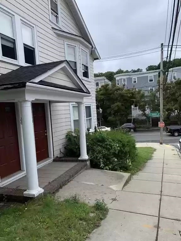 28 Tip Top Street, Unit 1 Boston, MA 02135 - Photo 2 of 13 a front view of a house with a yard