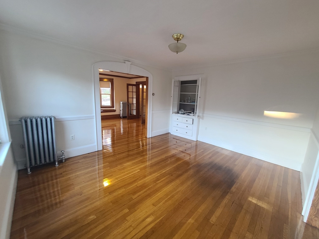 28 Tip Top Street, Unit 1 Boston, MA 02135 - Photo 8 of 13 wooden floor in an empty room